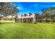 Gray farmhouse with wraparound porch and expansive yard at 8044 Lake Hatchineha Rd, Haines City, FL 33844