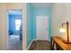 Inviting entryway with wood-look floors, leading to a bedroom and a light blue accent wall at 4850 St James Ct, Winter Haven, FL 33881