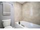 Beige tiled bathroom with a bathtub and shower at 12 Robyn Ln, Haines City, FL 33844