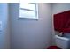 Small bathroom with toilet and a window at 997 Pearly Ridge Ln, Lakeland, FL 33809