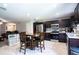 Modern kitchen with dark cabinetry, stainless steel appliances, and an adjacent dining area at 997 Pearly Ridge Ln, Lakeland, FL 33809