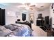 Main bedroom with a large bed, TV, and bathroom access at 997 Pearly Ridge Ln, Lakeland, FL 33809