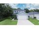 Two-story house with a two-car garage and well-maintained lawn at 997 Pearly Ridge Ln, Lakeland, FL 33809