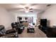 Spacious living room featuring leather furniture and a view into the kitchen and dining area at 997 Pearly Ridge Ln, Lakeland, FL 33809