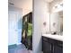 Bathroom with shower, vanity, and dark brown cabinets at 997 Pearly Ridge Ln, Lakeland, FL 33809