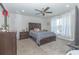 Comfortable bedroom with a queen-size bed and ceiling fan at 1439 Sarasota Dr, Kissimmee, FL 34759