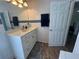 Clean bathroom with white vanity, tiled walls, and wood-look floors at 6750 Winterset Gardens Rd, Winter Haven, FL 33884