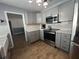 Updated kitchen featuring gray cabinets, quartz countertops, and stainless steel appliances at 6750 Winterset Gardens Rd, Winter Haven, FL 33884