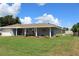 Ranch-style home with gray brick exterior and covered porch at 6750 Winterset Gardens Rd, Winter Haven, FL 33884