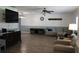 Living room with hardwood floors, comfy seating, and large TV at 6750 Winterset Gardens Rd, Winter Haven, FL 33884