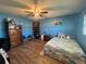Charming bedroom with blue walls, a double bed, and ample storage at 6750 Winterset Gardens Rd, Winter Haven, FL 33884