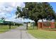 Community entrance with brick sign and gate at 6750 Winterset Gardens Rd, Winter Haven, FL 33884
