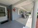Covered porch with seating and decorative accents at 6750 Winterset Gardens Rd, Winter Haven, FL 33884