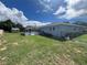 Home exterior and fenced backyard with pool at 6750 Winterset Gardens Rd, Winter Haven, FL 33884