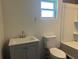 Updated bathroom with gray vanity, white toilet, and a bathtub at 6750 Winterset Gardens Rd, Winter Haven, FL 33884