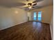 Main bedroom with hardwood floors and pool view at 6750 Winterset Gardens Rd, Winter Haven, FL 33884