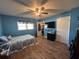 Serene bedroom with blue walls, a king-size bed, and a walk-in closet at 6750 Winterset Gardens Rd, Winter Haven, FL 33884