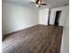 Large bedroom with hardwood floors and ceiling fan at 6750 Winterset Gardens Rd, Winter Haven, FL 33884