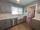 Modern kitchen with gray cabinets, farmhouse sink, and quartz countertops at 6750 Winterset Gardens Rd, Winter Haven, FL 33884