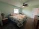 Spacious bedroom with floral bedding and wood-look flooring at 6750 Winterset Gardens Rd, Winter Haven, FL 33884