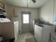 Functional laundry room with washer, dryer, and exterior access at 6750 Winterset Gardens Rd, Winter Haven, FL 33884