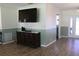 Living room boasts hardwood floors and a large TV at 6750 Winterset Gardens Rd, Winter Haven, FL 33884