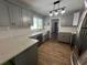 Updated kitchen featuring gray cabinets and white subway tile backsplash at 6750 Winterset Gardens Rd, Winter Haven, FL 33884