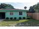 Side view of mint green house with fence at 15 Winterset Dr, Winter Haven, FL 33884