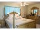 Bright bedroom featuring a large bed and wooden dresser at 15 Winterset Dr, Winter Haven, FL 33884