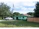 Mint green house with yard and parked SUV at 15 Winterset Dr, Winter Haven, FL 33884