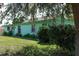 Mint green house partially shaded by tree at 15 Winterset Dr, Winter Haven, FL 33884