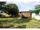 Large backyard with a shed and covered patio area at 15 Winterset Dr, Winter Haven, FL 33884