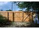 Newly installed wooden fence with double gates, providing privacy and security at 15 Winterset Dr, Winter Haven, FL 33884