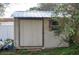 Outdoor storage shed with sliding door and window at 15 Winterset Dr, Winter Haven, FL 33884