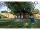 Large backyard with wooden fence, large tree, and a covered grill at 15 Winterset Dr, Winter Haven, FL 33884