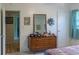 Well-lit bedroom with dresser and access to bathroom at 15 Winterset Dr, Winter Haven, FL 33884