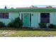 Closeup of mint green front door with wreath at 15 Winterset Dr, Winter Haven, FL 33884