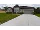 Gray house with a one-car garage and well-maintained landscaping at 169 Violet Ct, Kissimmee, FL 34759