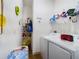 Bright laundry room with washer, dryer, and shelving for storage at 169 Violet Ct, Kissimmee, FL 34759