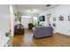 Spacious living room with hardwood floors, a large TV, and comfortable seating at 169 Violet Ct, Kissimmee, FL 34759