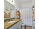 Stylish bathroom with granite countertop and a white shower curtain at 169 Violet Ct, Kissimmee, FL 34759