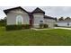 Gray house with a one-car garage and well-maintained landscaping at 169 Violet Ct, Kissimmee, FL 34759