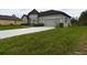 Gray house with a one-car garage and well-maintained landscaping at 169 Violet Ct, Kissimmee, FL 34759