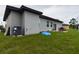Gray house exterior with backyard patio and playset at 169 Violet Ct, Kissimmee, FL 34759