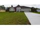 Gray house with a one-car garage and well-maintained landscaping at 169 Violet Ct, Kissimmee, FL 34759