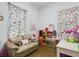 Fun playroom with butterfly curtains and a play kitchen at 169 Violet Ct, Kissimmee, FL 34759