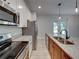 Modern kitchen featuring stainless steel appliances and granite countertops at 213 Cordova Rd, Auburndale, FL 33823