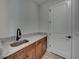 Laundry room with utility sink and wood cabinets at 213 Cordova Rd, Auburndale, FL 33823