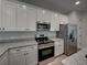 Modern kitchen with stainless steel appliances and white cabinets at 213 Cordova Rd, Auburndale, FL 33823
