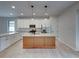 Modern kitchen with island, stainless steel appliances, and granite countertops at 213 Cordova Rd, Auburndale, FL 33823